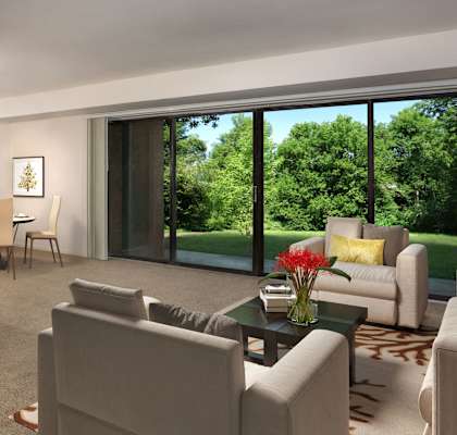 living room at Grandview apartments in Falls Church with couch and chair in the foreground and dining room area with table for four in the background