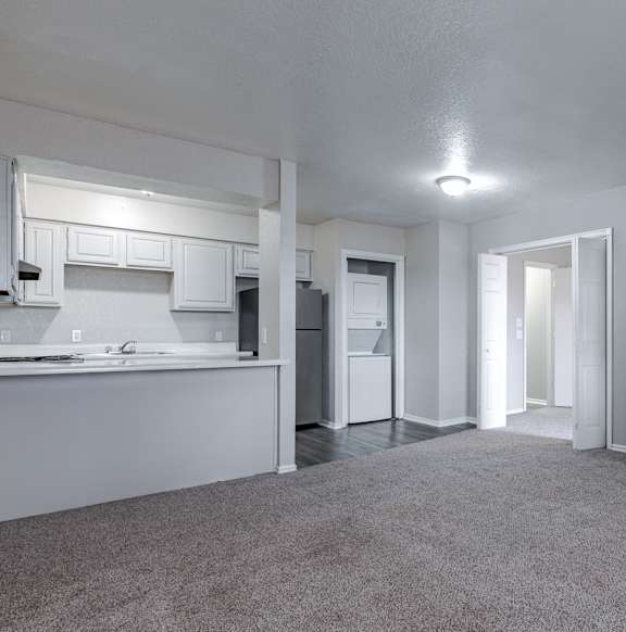 an empty living room and kitchen with a refrigerator at Diamond Ridge Apartments, Oklahoma, 73114