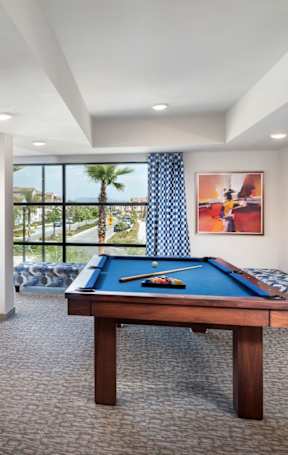 A modern dining room with a table set for six.