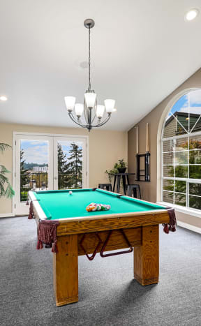 a large game room with a pool table