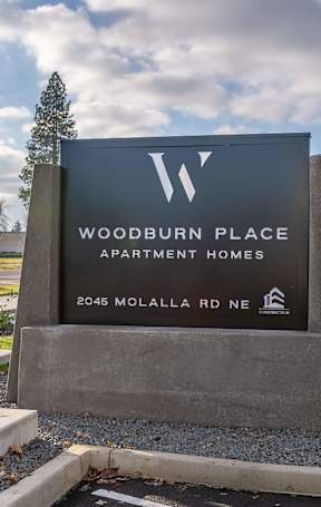 A spacious gym with a variety of equipment including treadmills, weights, and exercise machines at Woodburn Place Apartment Homes, Woodburn, OR, 97071