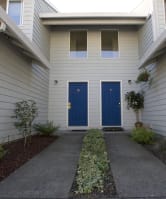 the front of a house with a driveway and a porch