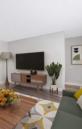 A living room with a green couch and a wooden coffee table.