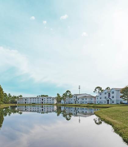 a view of a lake with houses and trees on the other side