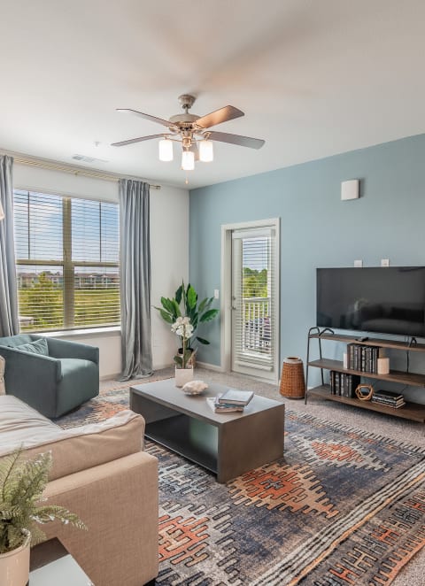 Spacious Living Room With Glass Patio Door Leading Out To Balcony