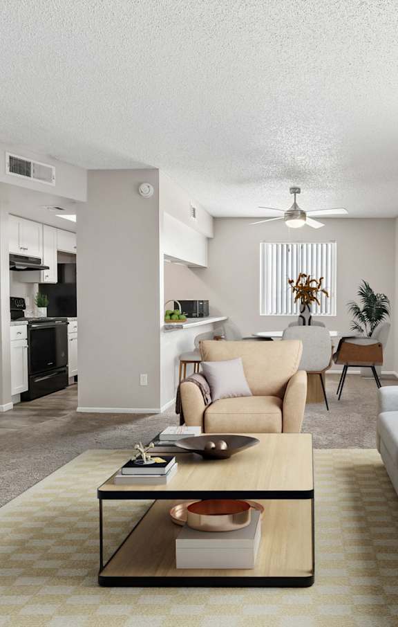 A living room with a grey couch, a wooden coffee table, and a flat screen TV.