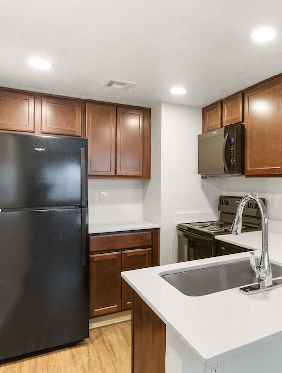 Kitchen with Black Appliances at Rio Seco Apartments