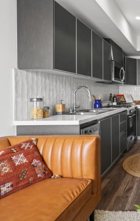 a kitchen and living room in a 555 waverly unit at The Fairfax Flats Apartments, Los Angeles, CA, 90019