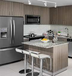 A modern kitchen with a dining table set for four. at Palma, Doral, FL, 33166