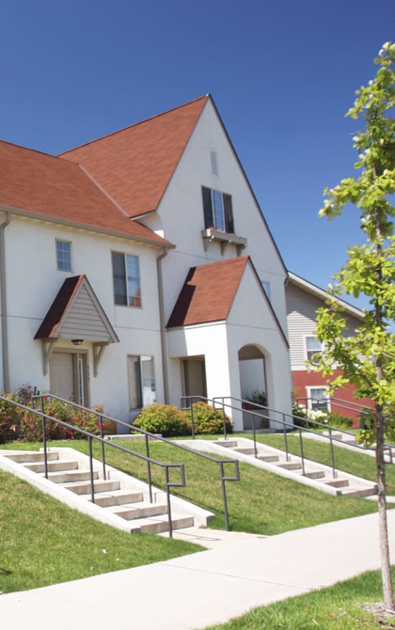 a row of houses with a sidewalk in front of them at Heritage Park apartments and townhomes in Minneapolis, MN