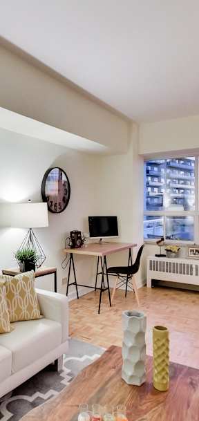 a living room with a couch and a table on a balcony