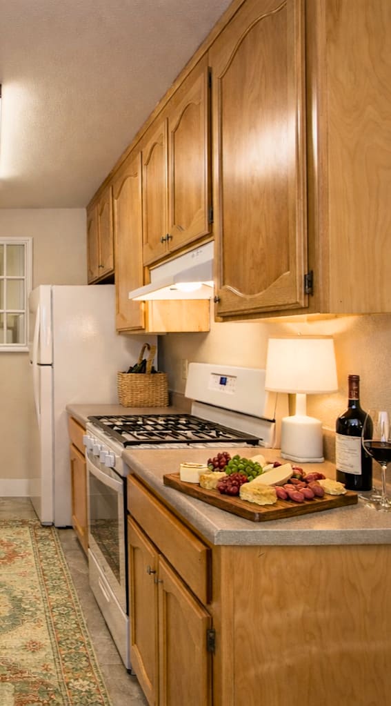 a large dining room with tables and chairs and windows  at Castle Vista Senior Duplex Community, Atwater, CA