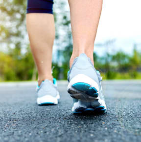 Woman walking down the road wearing sneakers at South Pine, Georgia