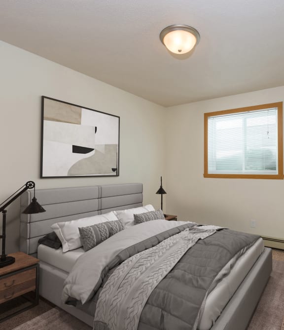 a bedroom with a large bed and a window