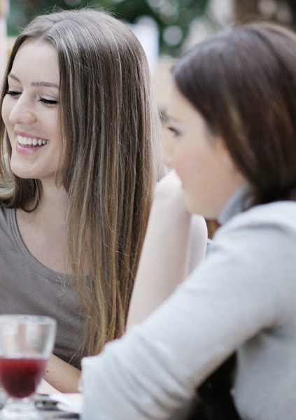 Three women are sitting at a table, laughing and enjoying each other's company.at Krewstown Park Apartments, Philadelphia, PA