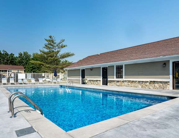 our resort style swimming pool is next to our building with lounge chairs