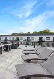 rooftop patio at the yards and backyards apartmens with sun chairs and planters