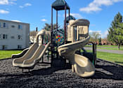 Thumbnail 34 of 38 - A playground with a slide and a tower.