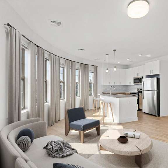 A modern living room with a grey sofa and a grey armchair.
