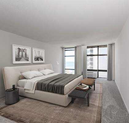 A bedroom with a large bed and a window overlooking a cityscape.