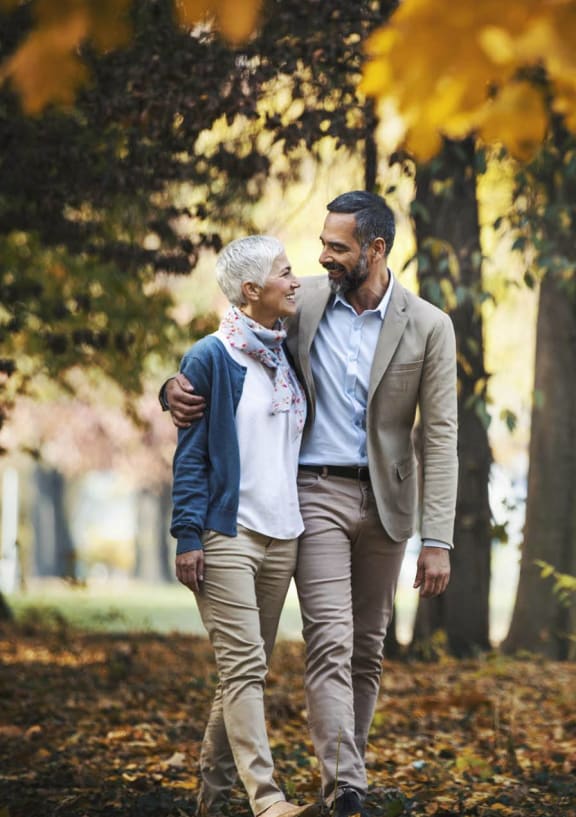 a man and a woman walking in the park