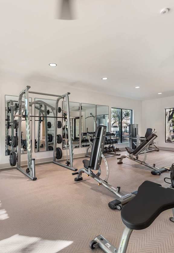 a woman holding a dumbbell in front of a mirror at Sedona Springs, Texas, 78749