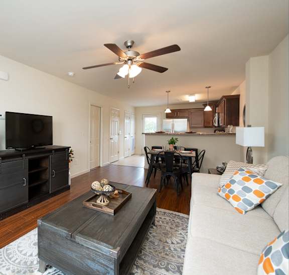 A living room with a television, a couch, and a coffee table.