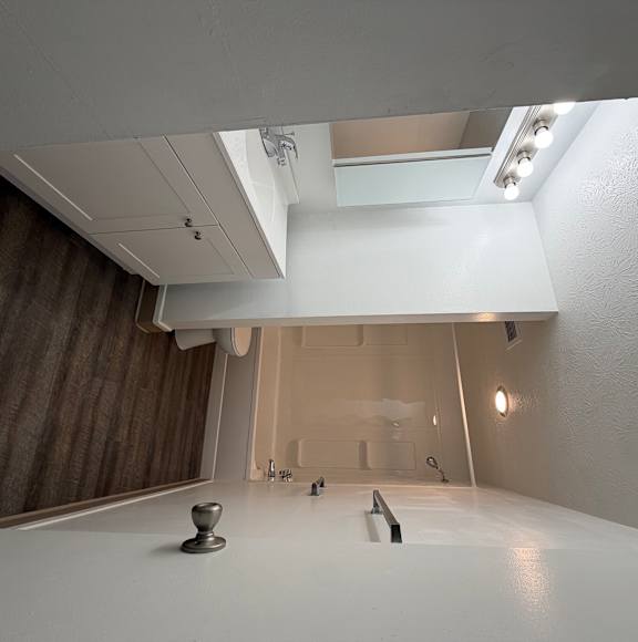 A white room with a staircase and a wooden wall.