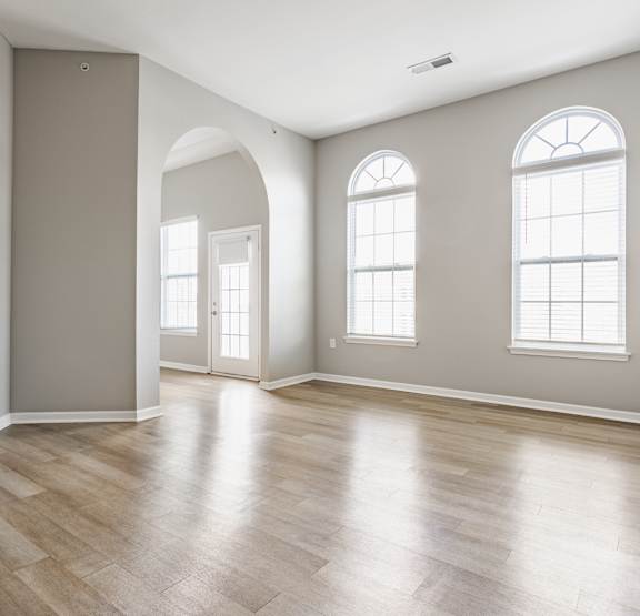 a vacant open concept living and kitchen room with plank flooring and luxury finishes at Alexandria of Carmel Apartments, Indiana