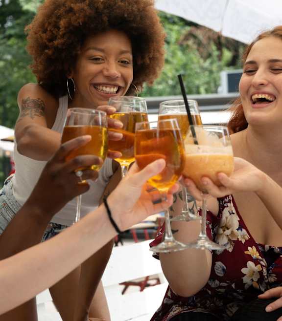 Four female friends drinking at Queen St East in Scarborough, ON