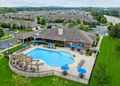 Thumbnail 9 of 34 - A large swimming pool surrounded by a fence and lounge chairs. at The Villas at Nature Walk, Huntsville, Alabama