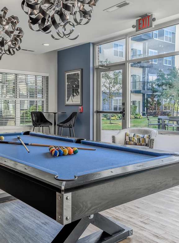 a game room with a foosball table and two stools