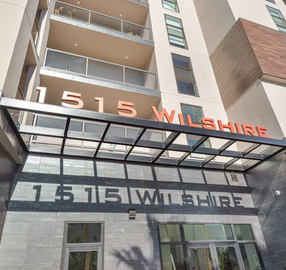 The Wilshire building has a modern design with a glass facade at Wilshire Valencia Apartment, California