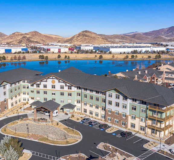 A large building with a pool in front of it.at Mountain Lakes Estates Apartments, Reno, Nevada