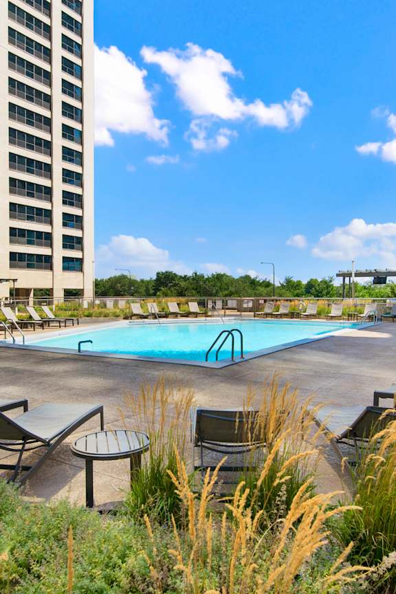 Rooftop pool deck with lounge chairs and ornamental grasses at Eleven Thirty Apartments, Chicago, 60605