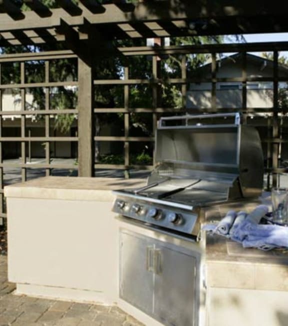 a stainless steel barbecue grill in a patio
