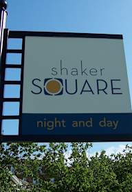 A sign for Shaker Square is displayed on a pole.