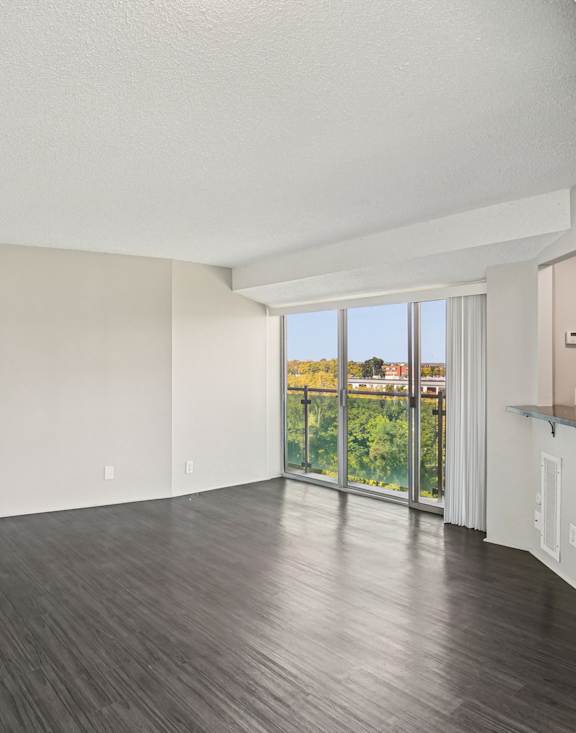 Spacious Empty Room with Wooden Flooring at Vista Condominiums, Kansas City, Kansas