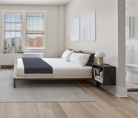 a bedroom with a bed and a white couch
