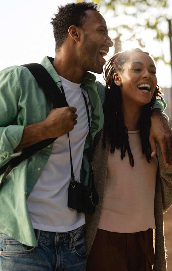 A man and a woman are walking together outdoors.