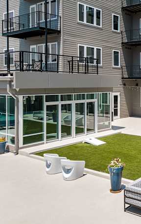 A modern apartment complex with a courtyard and seating area at 2200 LaSalle, St Louis, MO, 63104.