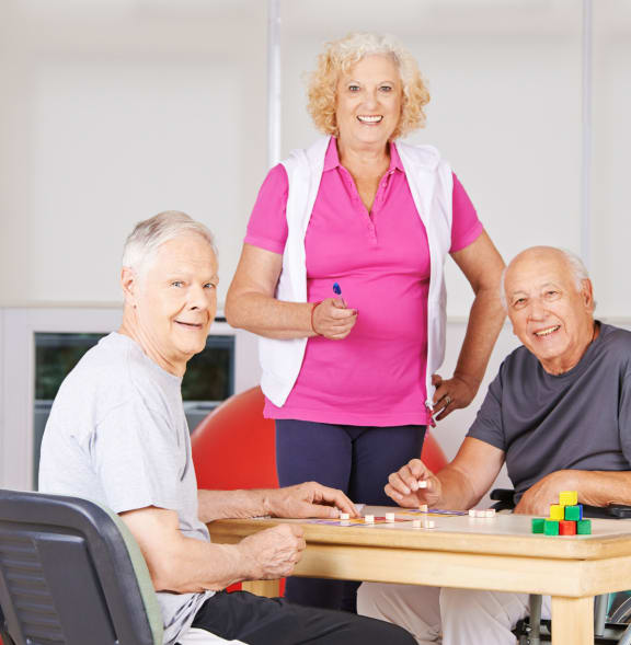 a group of seniors playing a game of chess on a table