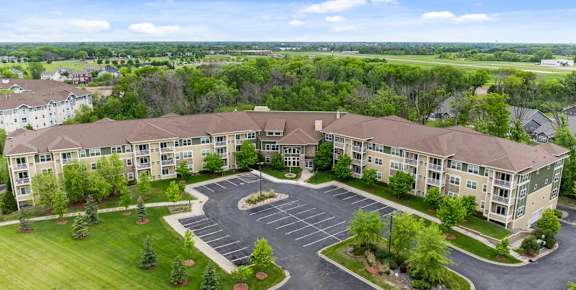 A large building with a parking lot in front of it.