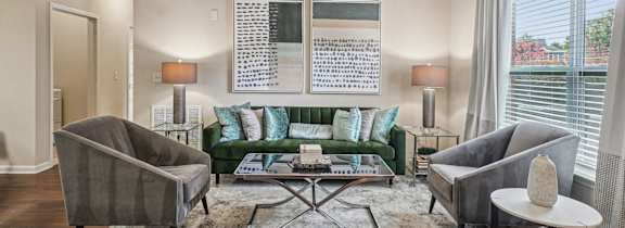 a living room with a couch and a ceiling fan