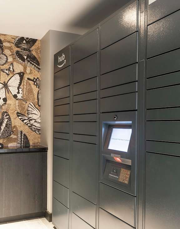 A wall with butterflies on it is behind a counter.