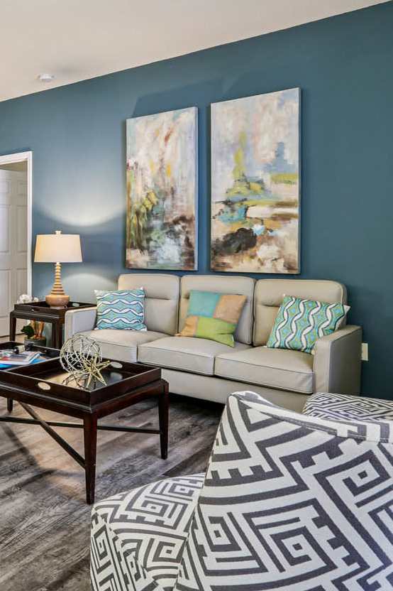 A living room with a patterned chair and a coffee table.