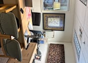 Thumbnail 7 of 14 - A room with a desk, chair, and computer.