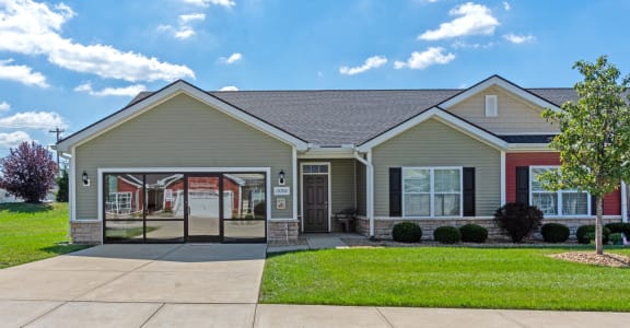 a house with a driveway and a lawn