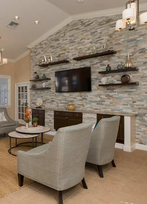 Community Living room with a fireplace at Sunrise Pointe, Port Orange, FL, Florida