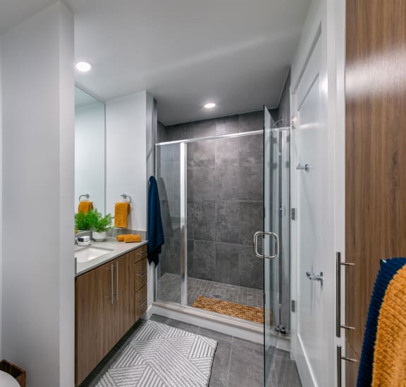 a small kitchen with a refrigerator and a washer and dryer in a closet